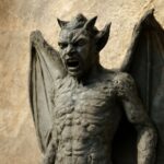 A horned gargoyle creature silhouetted against a desert sky in a Gothic horror illustration